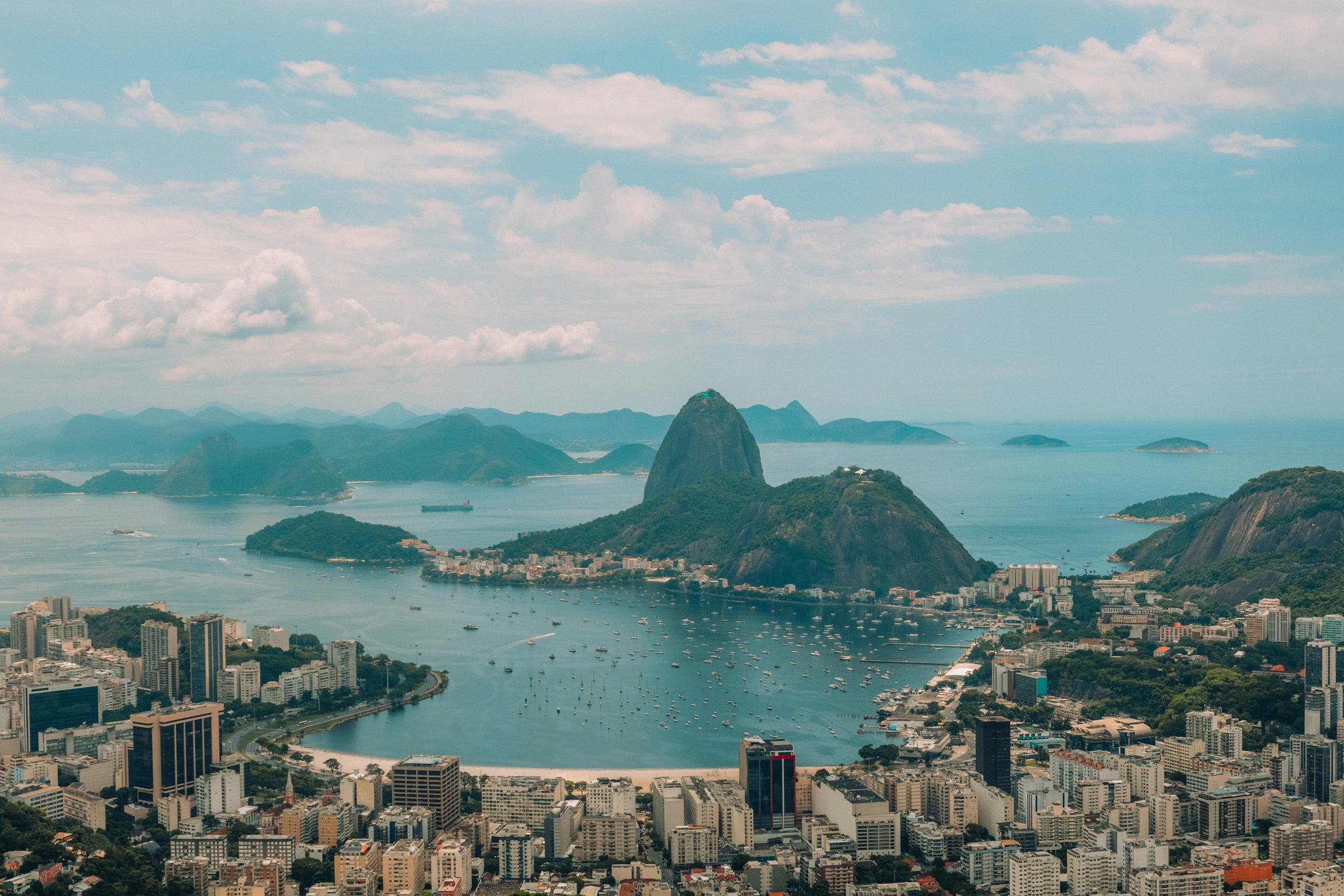 Breathtaking aerial view of Rio's iconic Sugarloaf Mountain and coastline, showcasing vibrant city life and natural beauty.